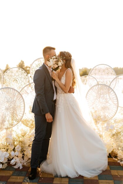 Bride and groom against the backdrop of a yellow sunset