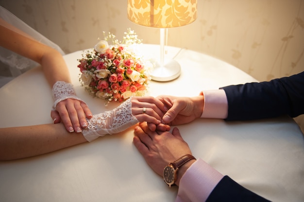 Bride and groom are sitting at a table in restaurant