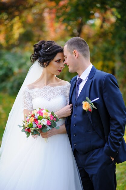 The bride and groom on autumn park.