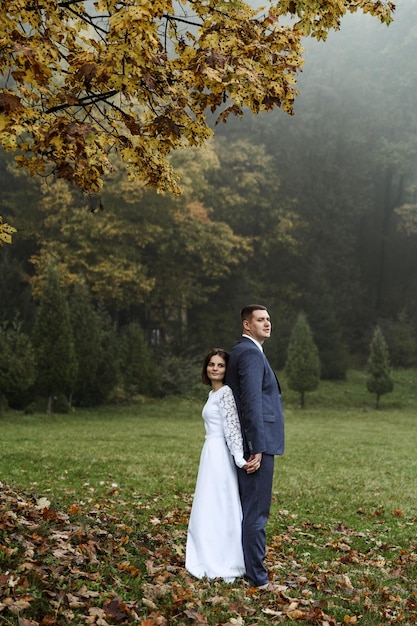 Bride and groom in autumn