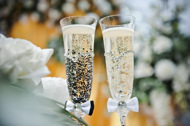 Photo bride and groom champagne glasses. wedding glasses of the bride and groom. glass decor.