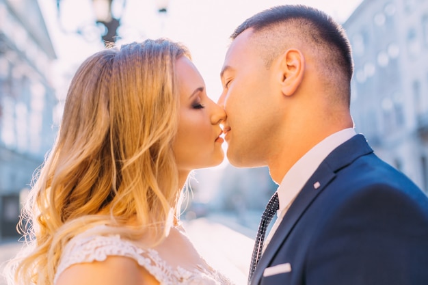 Bride and groom closed their eyes and kissed.