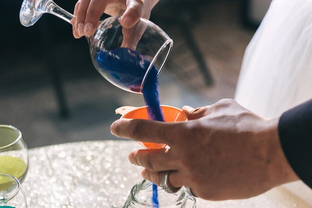 The bride and groom colorful sand is poured into the bottle Sand ceremony