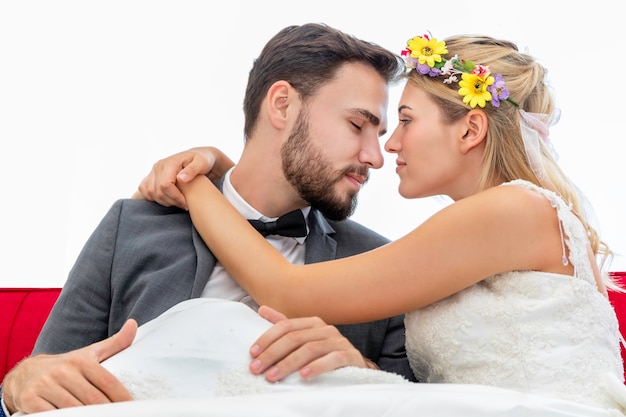 Bride and groom couple of Caucasian kiss and hug in wedding studio.