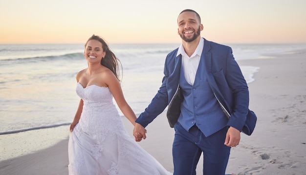 Bride groom and couple celebrate wedding on the beach during sunset on honeymoon vacation Man woman and marriage celebration with summer travel holiday as husband and wife at the ocean in hawaii