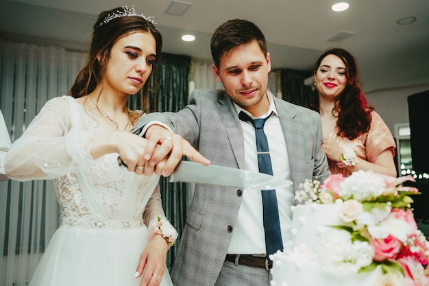 The bride and groom cut the cake