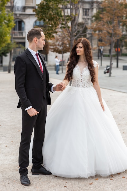 Bride and groom dancing in the old town street. 