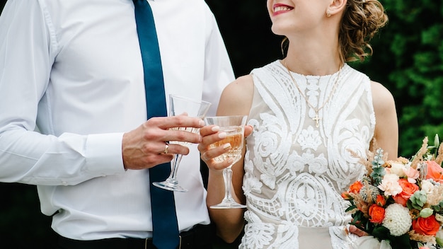 Bride and groom drinking champagne