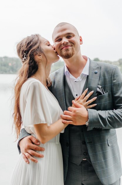 the bride and groom embrace