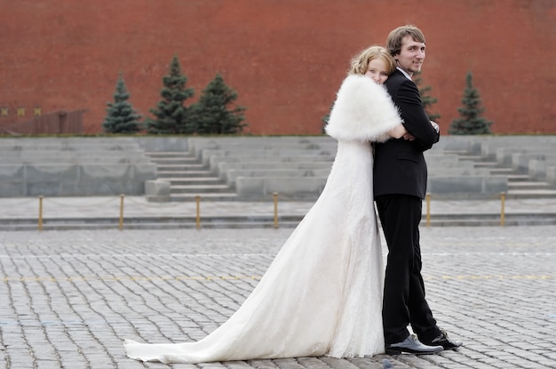 Bride and groom embracing outdoors