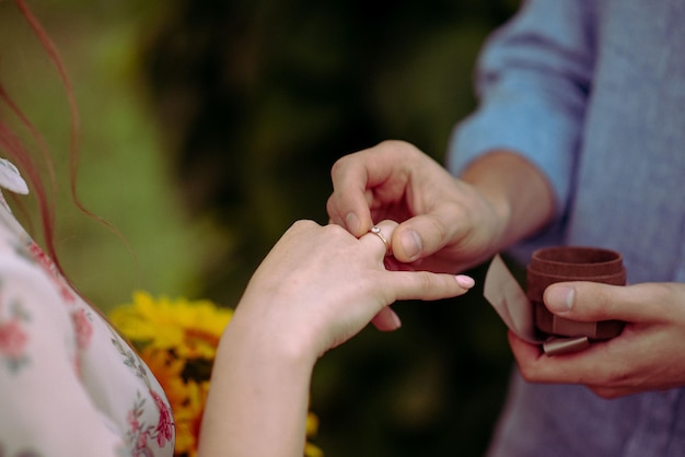 Bride and groom exchange rings at the wedding