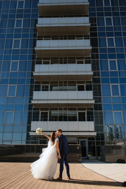 Bride and groom first meeting on the roof of skyscraper