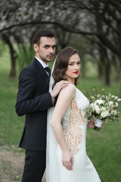 Bride and groom in the green forest