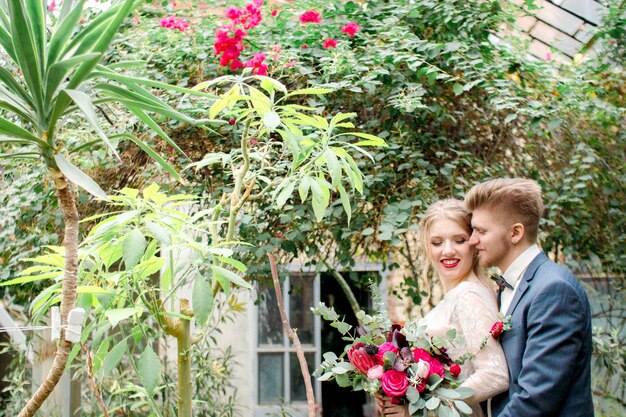 Bride and groom in greenhouse