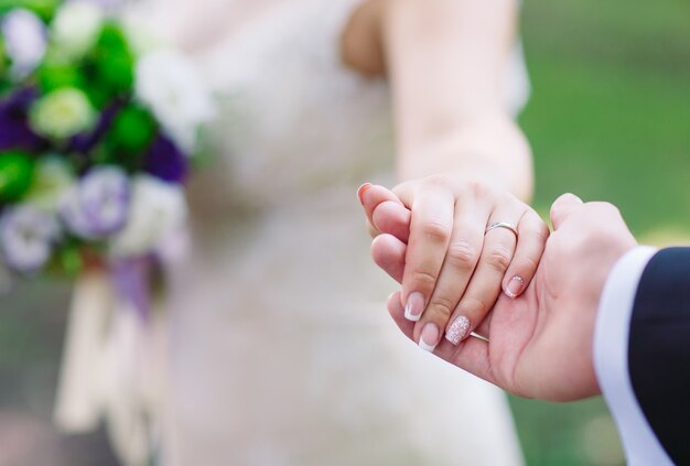 Bride and groom hands, close-up.