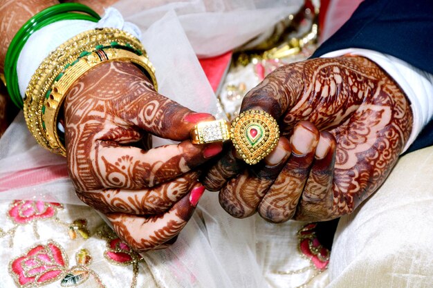 The bride and groom hands holding & showing wedding Jewelry Rings