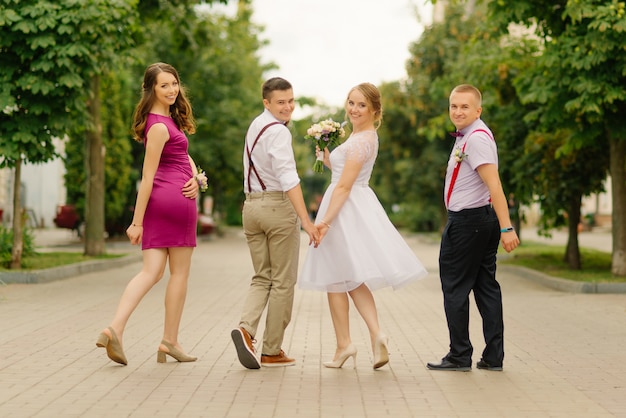 The bride and groom have fun with their friends on their wedding day.