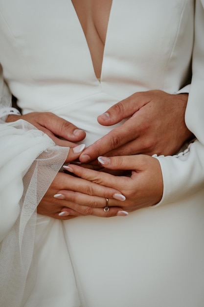 A bride and groom hold hands on their wedding day.