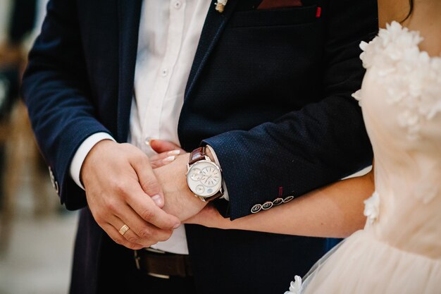 The bride and groom hold hands on the wedding ceremony bottom view Engagement