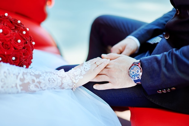 The bride and groom hold hands