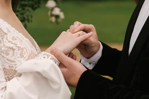 The bride and groom hold hands