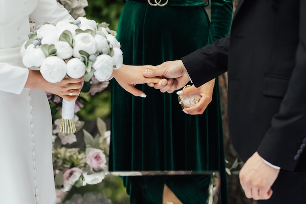 Bride and groom holding hands and looking at each other at wedding ceremony