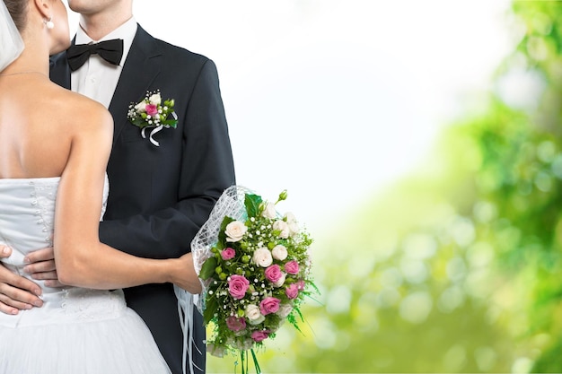 Bride and groom holding stylish bouquet during wedding ceremony