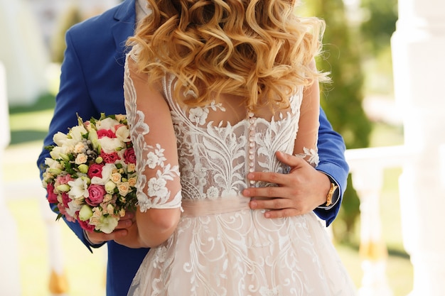 Bride and groom holding wedding bouquet