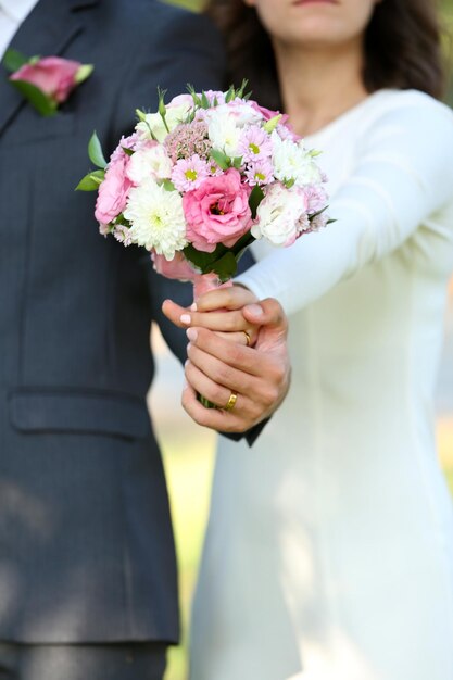 Bride and groom holding wedding bouquet