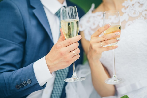 Bride and groom holding wedding champagne glasses