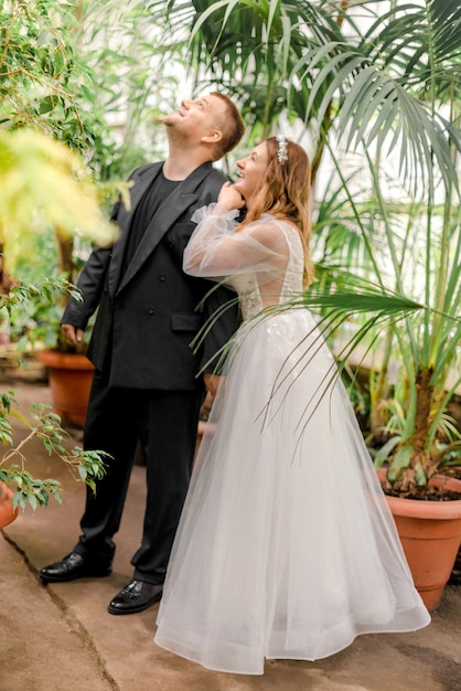 Bride and groom hugging in greenhouse