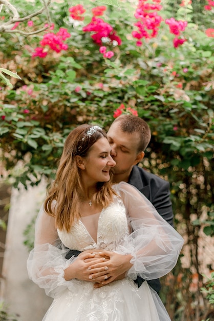 Bride and groom hugging in greenhouse