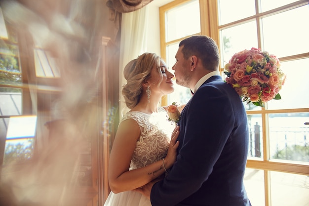 Bride and groom hugging and kissing forever