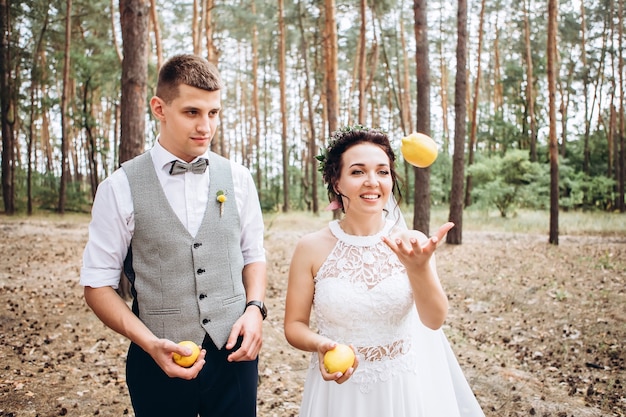 Bride and groom hugging, kissing outdoors on a wedding day, young couple, valentine's day