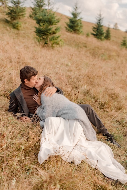 Bride and groom hugging in mountains