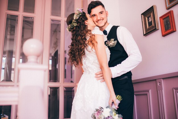 Bride and groom hugging on wedding day