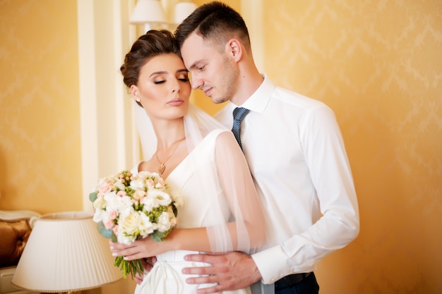 a bride and a groom hugging