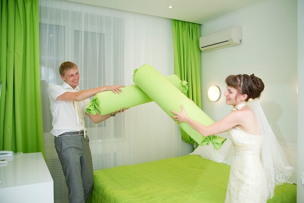 The bride and groom in an interior in the hotel room