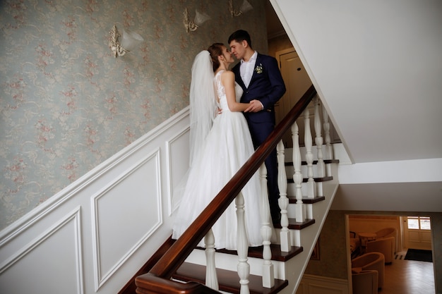 bride and groom kiss on the stairs