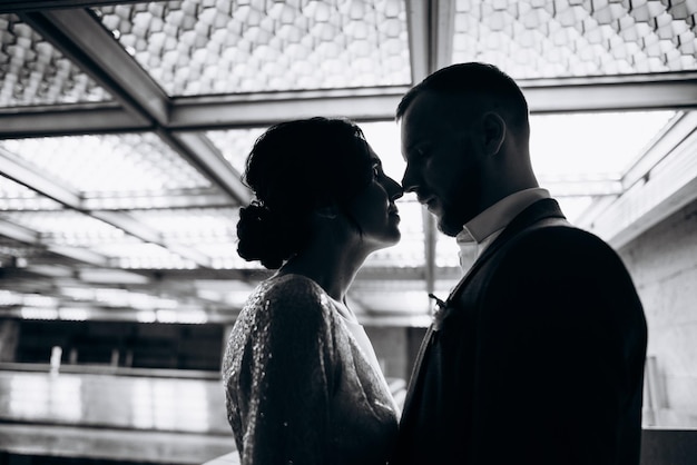 Bride and groom kissing each other with closed eyes