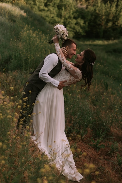 Bride and groom kissing in the park