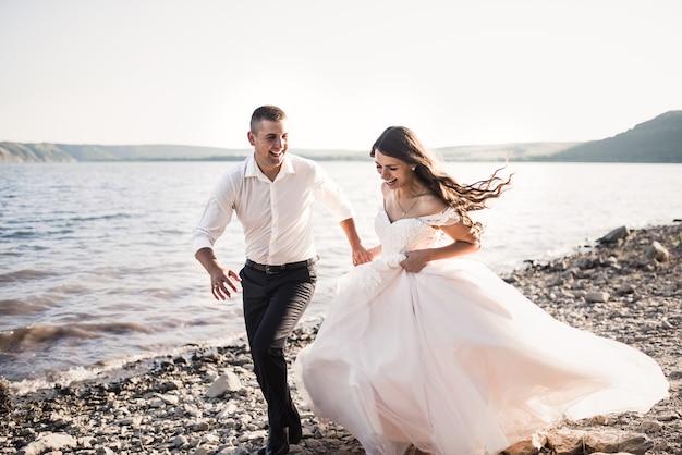 bride and groom laughing run together