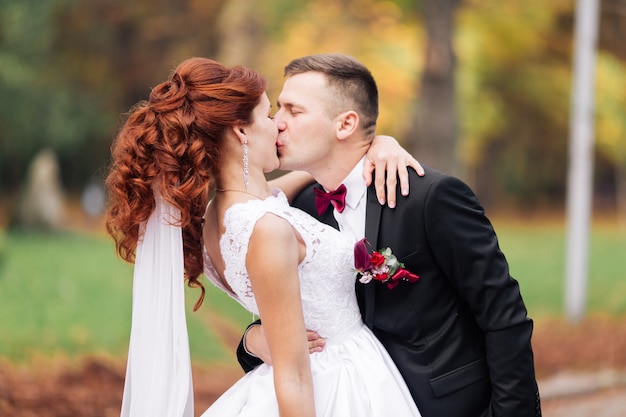 Bride and groom in the park. groom at wedding in nature green forest. Couple.