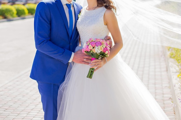 Bride and groom in a park among the trees