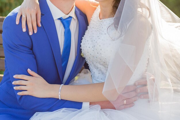 Bride and groom in a park among the trees