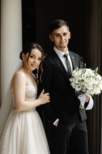 a bride and groom pose for a photo