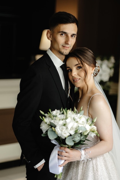 a bride and groom pose for a photo