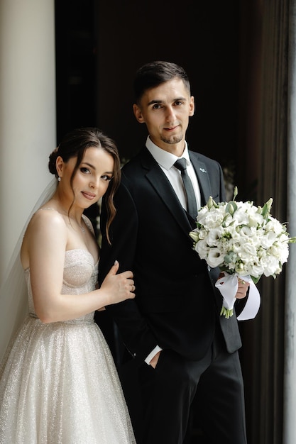 a bride and groom pose for a photo