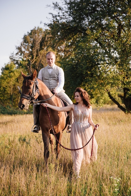 Bride and groom posing across the field