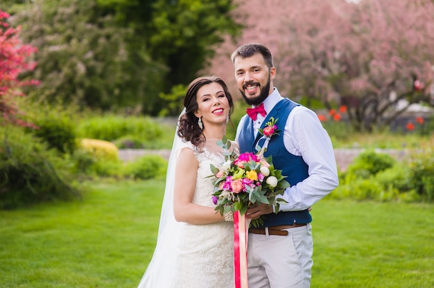 Bride and groom posing in beautiful garden